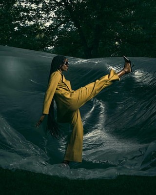 black woman fashionable woman mustard suit confident stride outdoor style elegance black tarp outdoor fashion stylish pose confident pose thumbnail